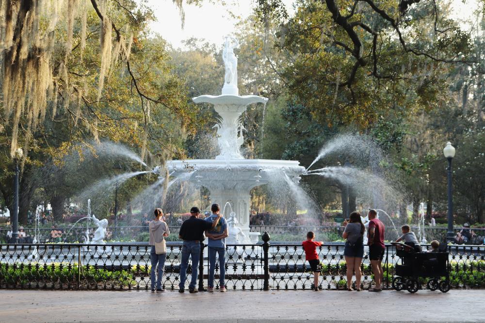 Visitors stand before the Forsyth Park fountain, one of Savannah's most popular tourist hotspots.
