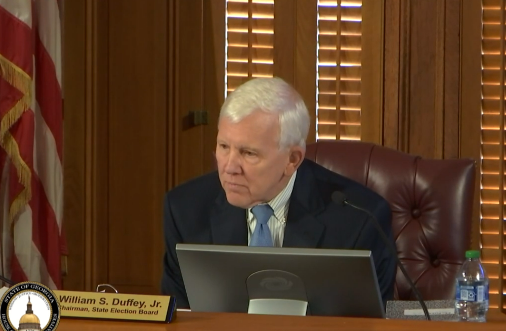William Duffey is shown speaking as chairman of the State Election Board.