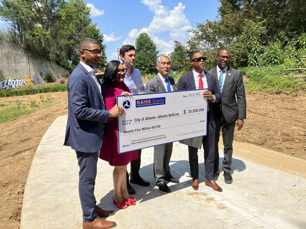 On hand for a giant $25 million federal Rebuilding American Infrastructure with Sustainability and Equity (RAISE) check presentation ceremony on a future segment of the Northeast Trail on July 24 are, from left, Christopher Coes, Nikema Williams, Jon Ossoff, Alex Wan, Clyde Higgs and Solomon Caviness