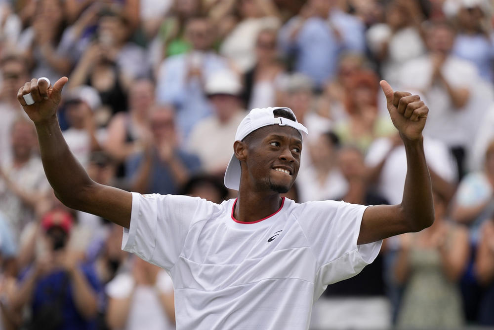 Christopher Eubanks of the U.S. celebrates after beating Stefanos Tsitsipas of Greece in a men's singles match on Day 8 of the Wimbledon tennis championships in London, Monday, July 10, 2023. 