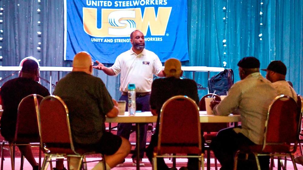 Alex Perkins a staff representative with the United Steelworkers speaks to Blue Bird employees during a training session for the bargaining committee in June.