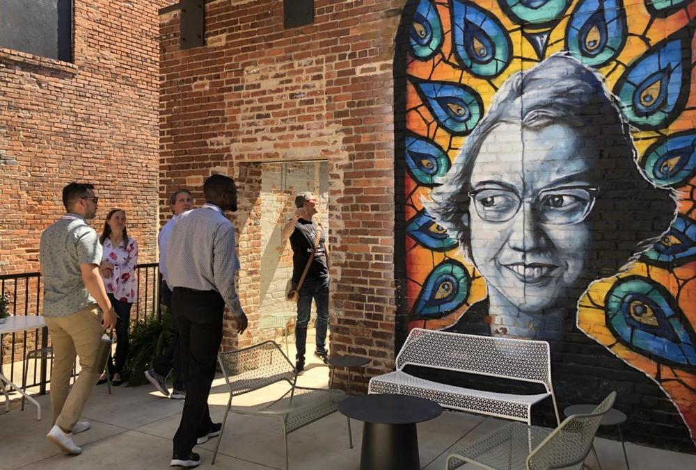 Kevin Scene Lewis’ portrait of Flannery O’Connor outside the Quill lounge at the Woodward hotel is one of a growing number of murals in downtown Macon. (Liz Fabian)