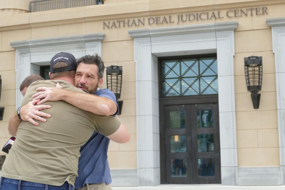 Operation Save America National Director Jason Storms hugs a fellow anti-abortion leader.