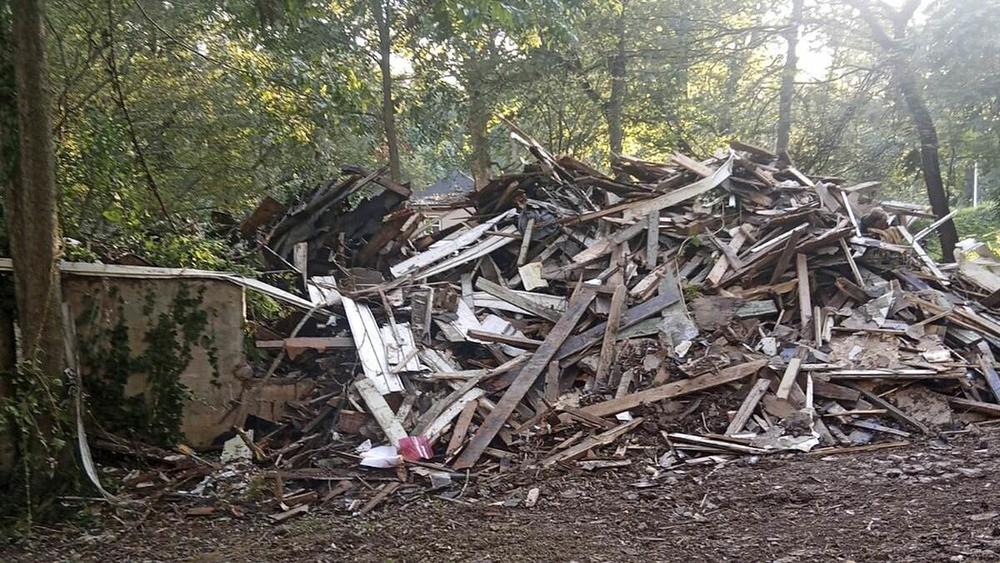 In this photo provided by Susan Hodgson, her mistakenly demolished family home sits in a pile of lumber and debris in southwest Atlanta, Georgia, on Sept. 15, 2023. 