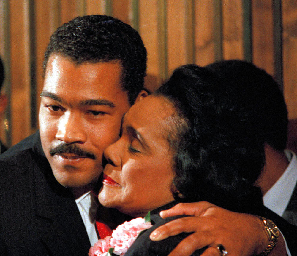 Dexter Scott King, youngest son of Dr. Martin Luther King, Jr., gets a hug from his mother, Coretta Scott King, at a news conference, Jan. 14, 1989, in Atlanta where it was announced that he would replace her as president of the King Center as of April 4.