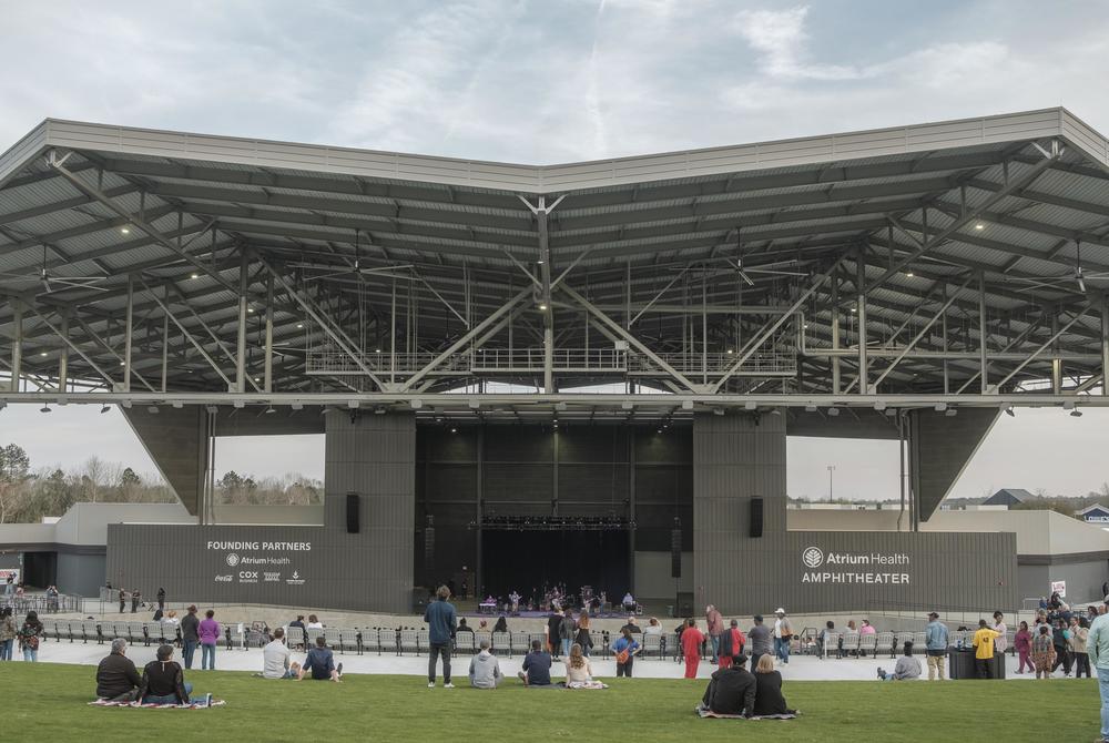 The Atrium Health Amphitheater can accomodate 12,000 people, mostly through expansive green space and covered seating. 