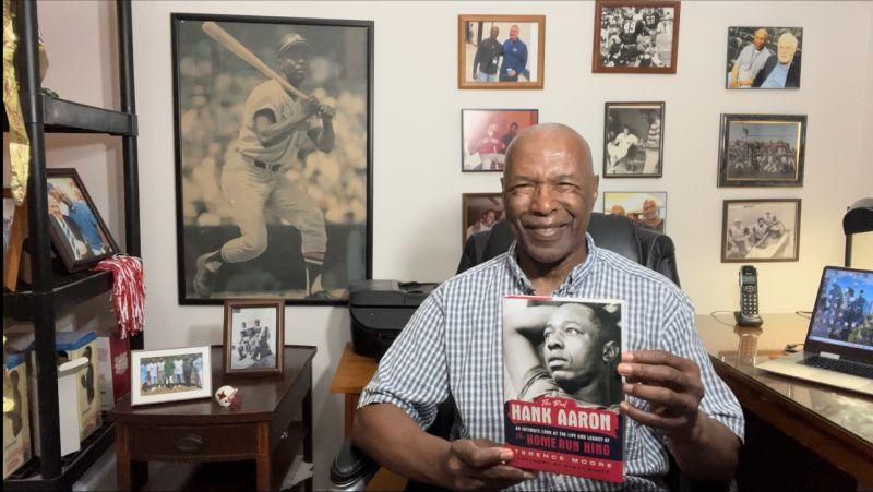 Sports journalist Terence Moore displays his book "The Real Hank Aaron"