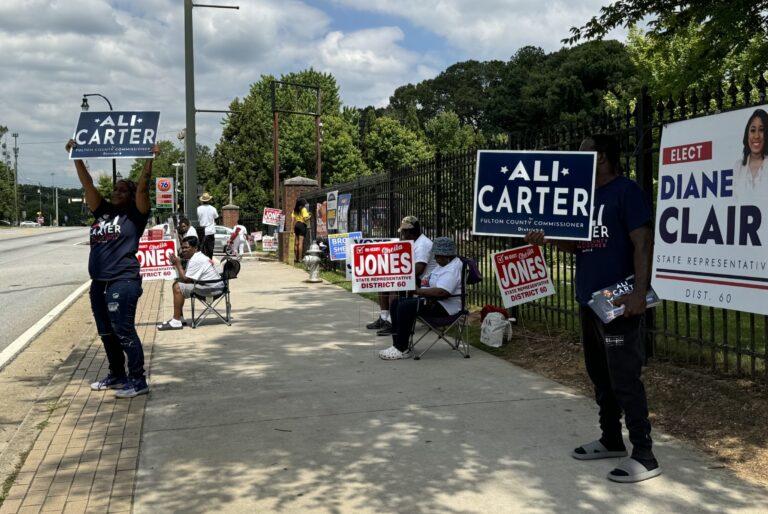 Sign wavers stood outside a west Atlanta polling place Tuesday trying to convince passing motorists to stop and vote.