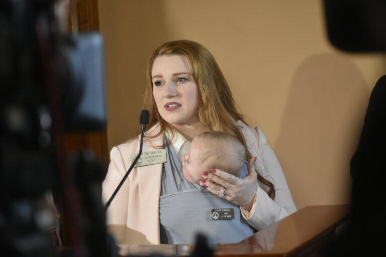 Rep. Lauren Daniel, a Locust Grove Republican, speaks at a press conference with son Zane. 
