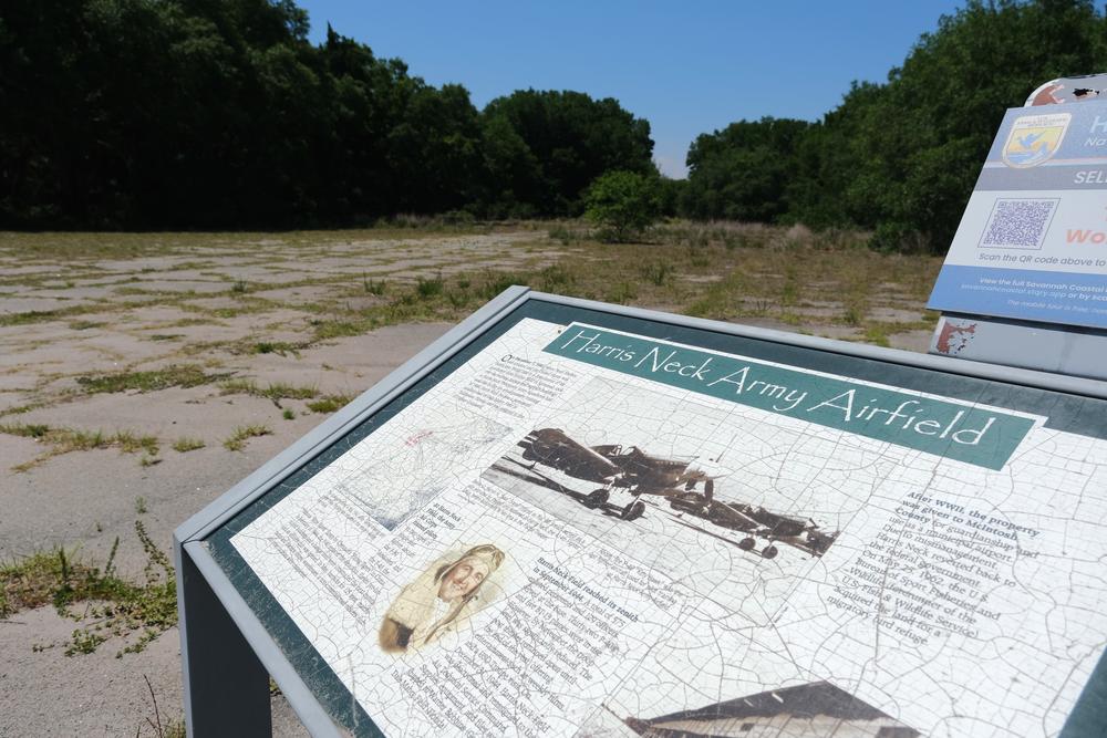 A U.S. Fish and Wildlife Service interpretive sign at the site of the former Harris Neck Army Airfield gives a timeline of the military installation, without mentioning the federal government's takeover of Harris Neck through eminent domain.