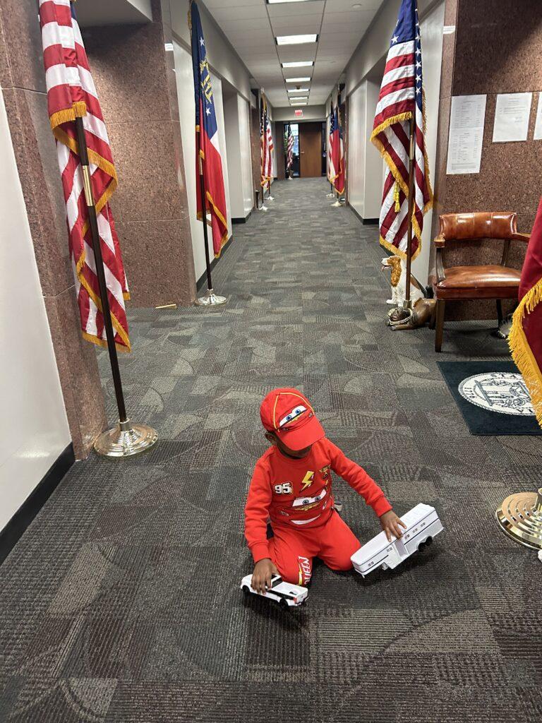 Sen. Kim Jackson’s son plays in the hallway of the legislative office building. 