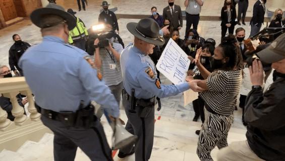 Rep. Park Cannon is confronted by a state trooper in the Capitol rotunda in February 2021, a separate incident from her arrest the following month. The Georgia Supreme Court is set to decide on a case over Georgians’ right to demonstrate inside the Capitol.