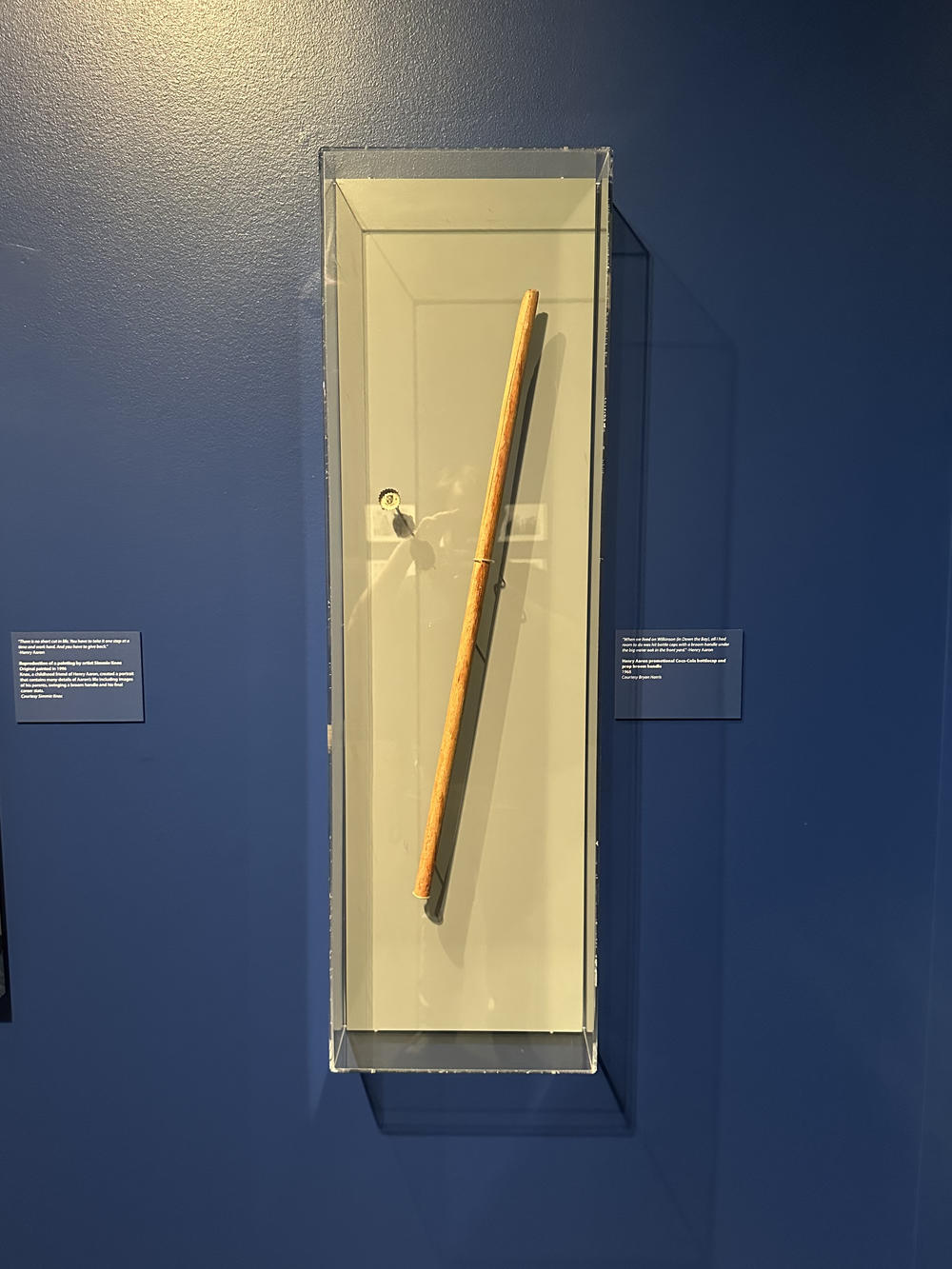 A stick and bottle cap is displayed at the Atlanta History Center's "More Than Brave" exhibit. These items represent Hank Aaron's earliest games as a baseball player.