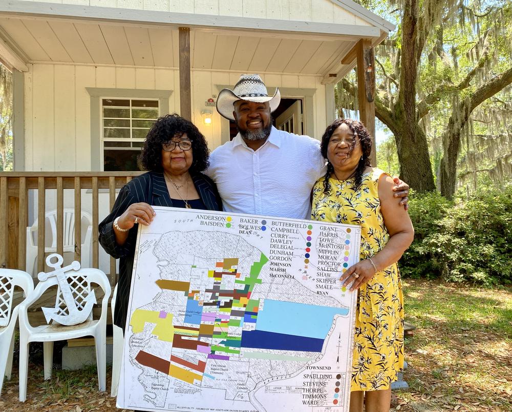 Direct Descendants of Harris Neck Community founder and president Frances Timmons, vice president Tyrone Timmons and administrative assistant Margaret Timmons Finley pose next to their group's office on Harris Neck Road in McIntosh County, Georgia.