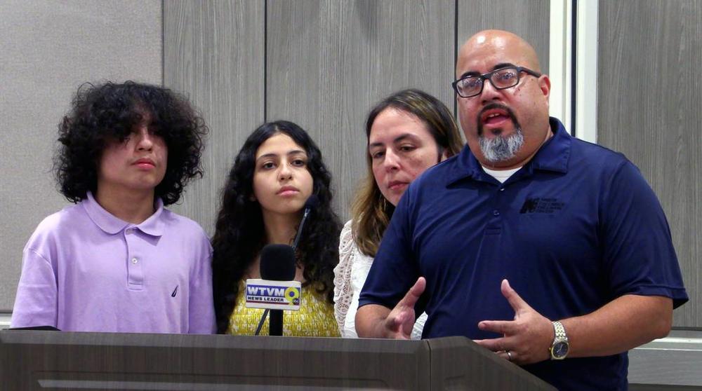 Luis Velez., right, speaks during the press conference Thursday afternoon at Piedmont Columbus Regional Hospital in Columbus, Georgia. With him are, from left, his son Alex, daughter Ella, and wife Lorna.
