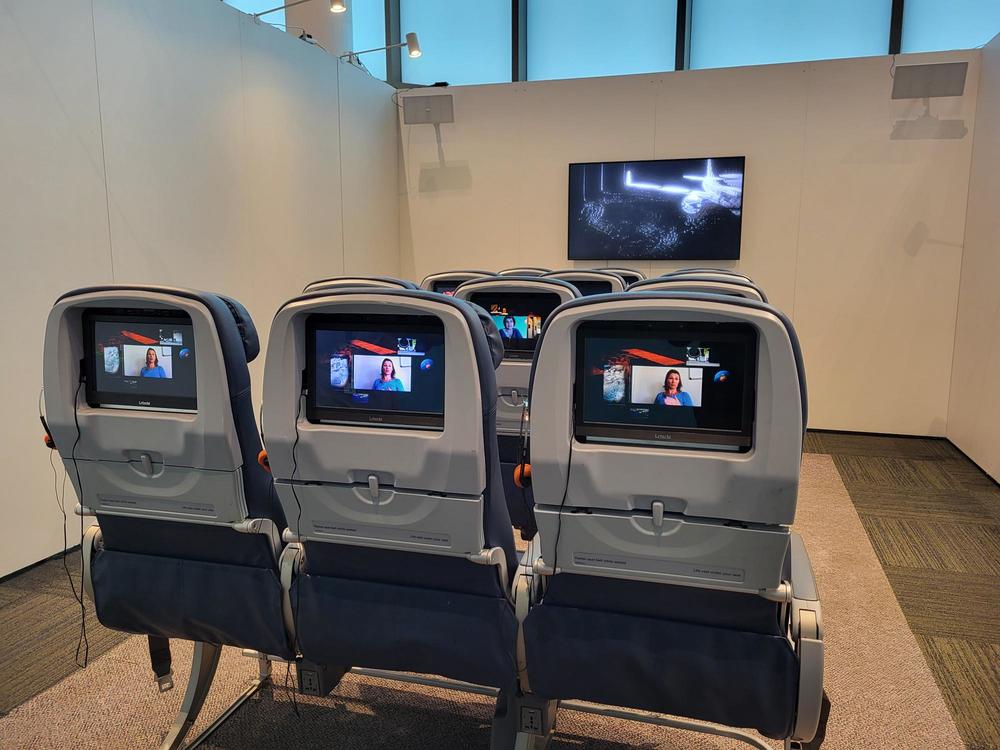 Four rows of three airline seats are part of an art installation at the CDC Museum in Atlanta.