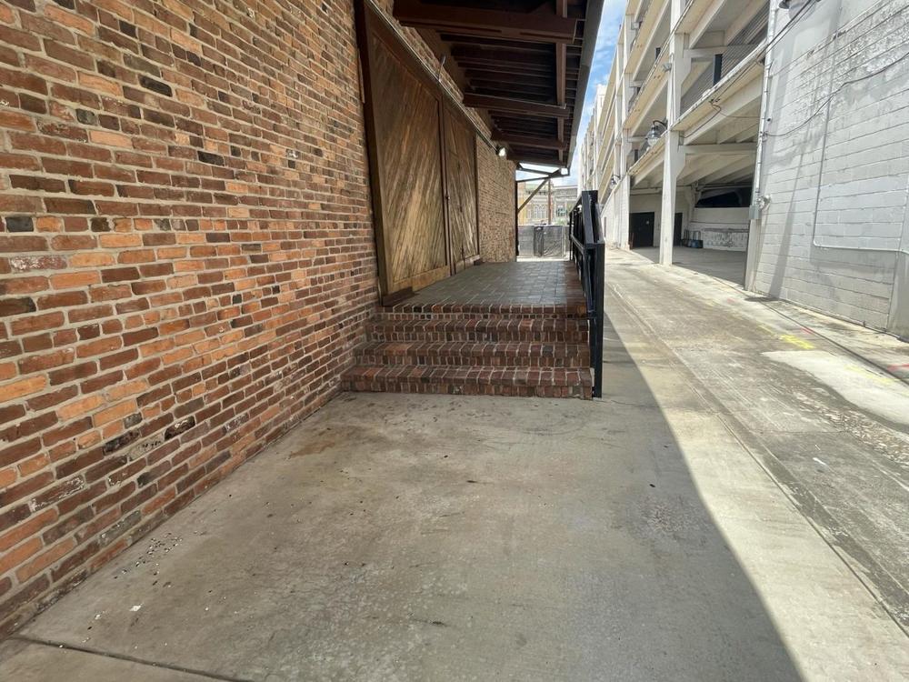 Albert Kenneth Knight Jr. was asleep on the stoop in this downtown alley when he was bludgeoned to death with a cinder block late May 24, 2024. His body was discovered just before noon May 26. Bloodstains, though fading, remained two weeks later. (Laura Corley | The Macon Newsroom)