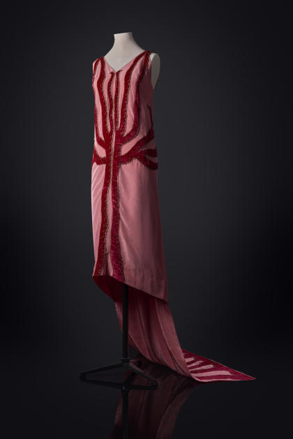 Madeleine Vionnet's Flame Dress (Spring/Summer 1923, France) is a pink silk moiré dress with dark pink velvet flame appliqué motif and gold metallic embroidery.  It's part of the Entering Modernity: 1920s Fashion from the Parodi Costume Collection exhibition at SCAD Fash through August 25, 2024.