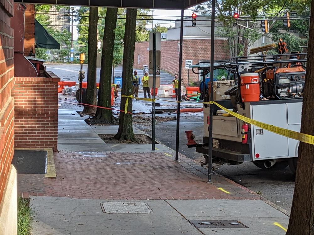 Crews managed to curb the violent flow of water seen over the weekend beside Eleventh Street Pub from the 11th Street water main break in Midtown on June 3 as repairs continue. (Photo by Beth McKibben)