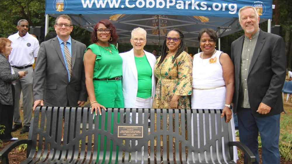 Cobb County Community Members posed for pictures in front of the bench honoring the legacy of historic African American author, Toni Morrison, and a former enslaved family of a mother and three children. (Friends of the Concord Bridge)