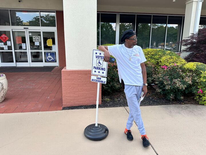 Lamont Hart, a voter protection volunteer for the New Georgia Project, waits to speak with voters outside the Cobb County Senior Wellness Center in Marietta, Ga. He was one of many election monitors during May’s primary. Matt Vasilogambros/Stateline