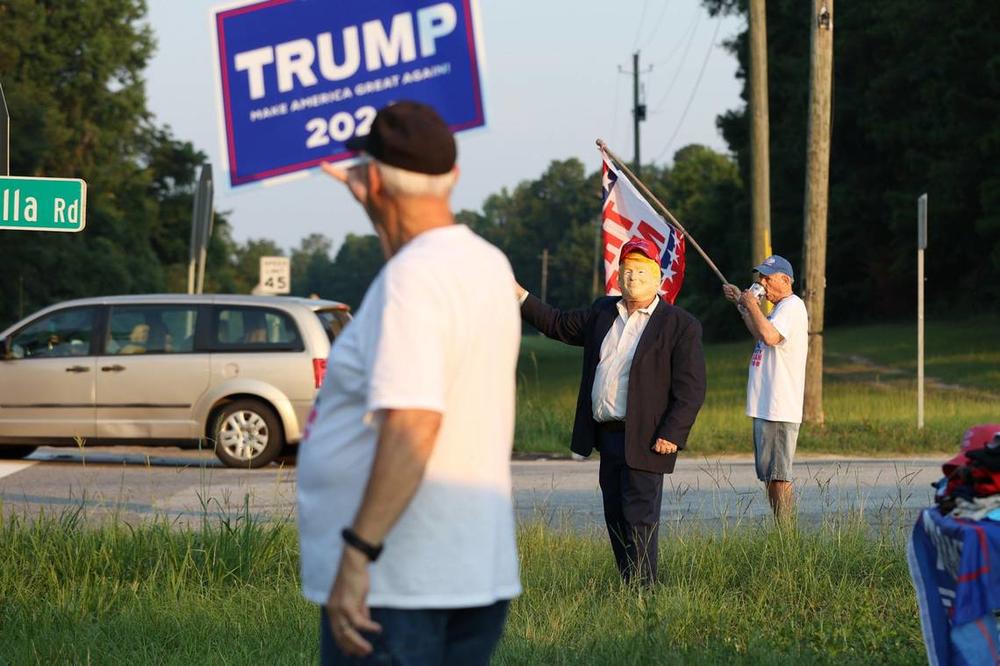 From left to right: Aubrey Clark, David Sumrall and Douglas Burnam show support for presidential candidate and former president Donald Trump on the side of Eisenhower Parkway on Monday, July 15, 2024, in Lizella, Georgia. A half dozen supporters, including members of the Bibb County Republican Party, gathered two days after an attempted assassination attempt on Trump in Pennsylvania with plans to move throughout the area over the course of the day. Katie Tucker/The Telegraph