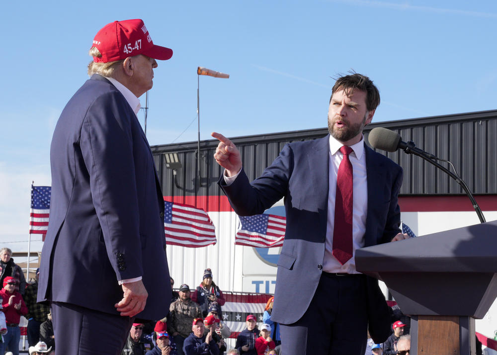 Sen. J.D. Vance is shown at a lectern speaking to former President Donald Trump.