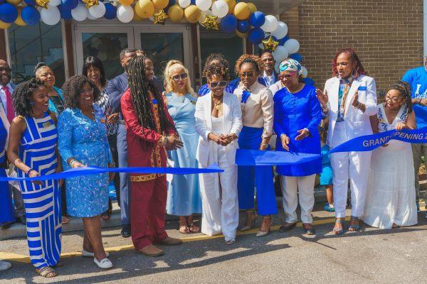A group of people watch as Tabatha McGee cuts the ribbon to open the Sickle Cell Sanctuary in Atlanta June 18, 2024.