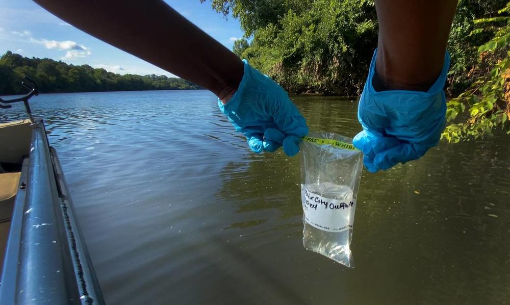 Vanisha Estrahota, Columbus technical programs fellow, takes a water sample from the Chattahoochee River near the outfall pipe for Phenix City, Alabama’s wastewater treatment plant. 07/10/2024 Mike Haskey/Ledger-Enquirer