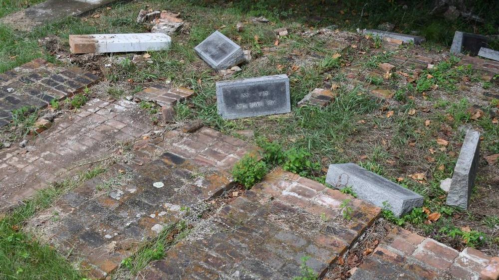 Headstones from the Woolfolk family sit overturned in the Rose Hill Cemetery on Wednesday, July 17, 2024, in Macon, Georgia. The Woolfolk family marker includes nine family members who were murdered in 1887. The area was vandalized this month. Katie Tucker/The Telegraph