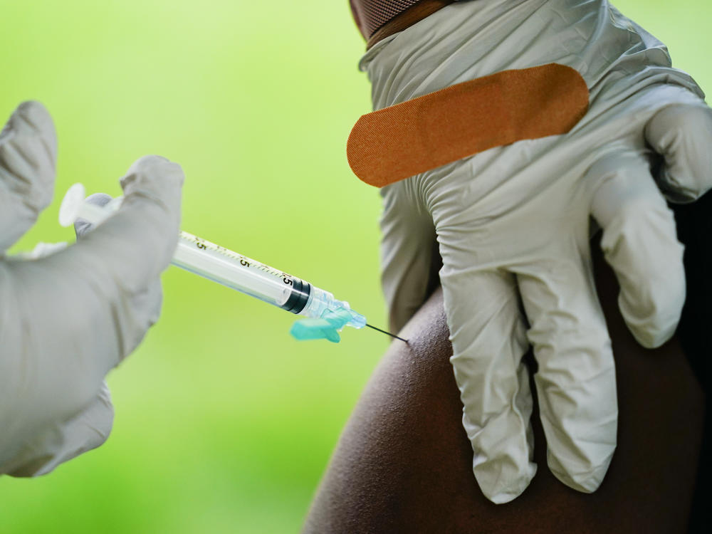 A health worker administers a dose of a Pfizer COVID-19 vaccine during a vaccination clinic at the Reading Area Community College in Reading, Pa., Tuesday, Sept. 14, 2021.