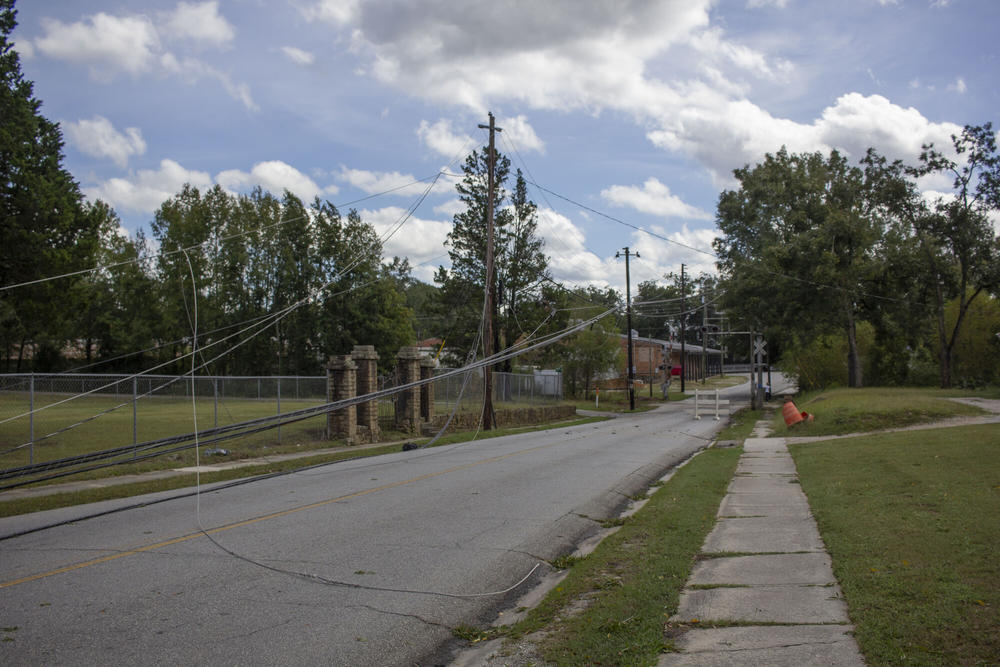 Powerlines lie toppled in the empty streets of Sparta on Friday, Sept. 27.