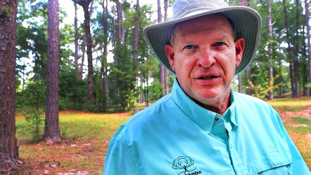 Arborist George Barker talks about the need to prioritize trees growing in communities and soil health at Carver Park in August 2024. Kala Hunter/Ledger-Enquirer