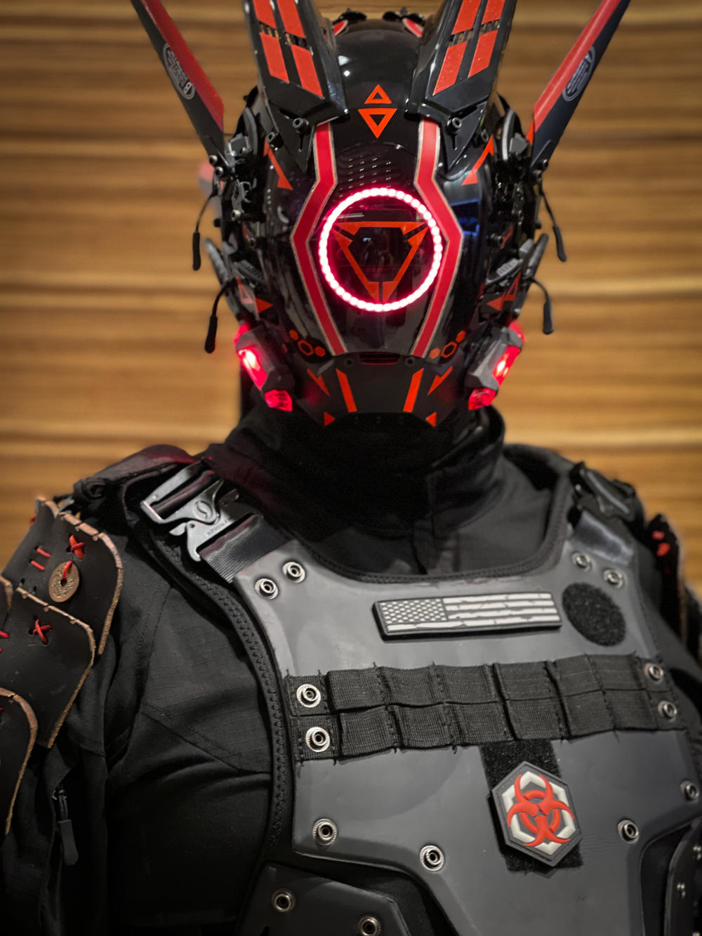 A Dragon Con cosplayer wears an intricate red and black mask complete with LED lights in 2024.