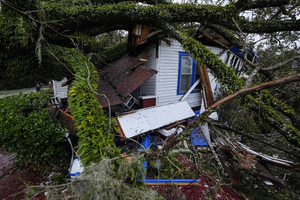 A damaged 100-year-old home is seen after an Oak tree landed on it after Hurricane Helene moved through the area, Friday, Sept. 27, 2024, in Valdosta, Ga. 