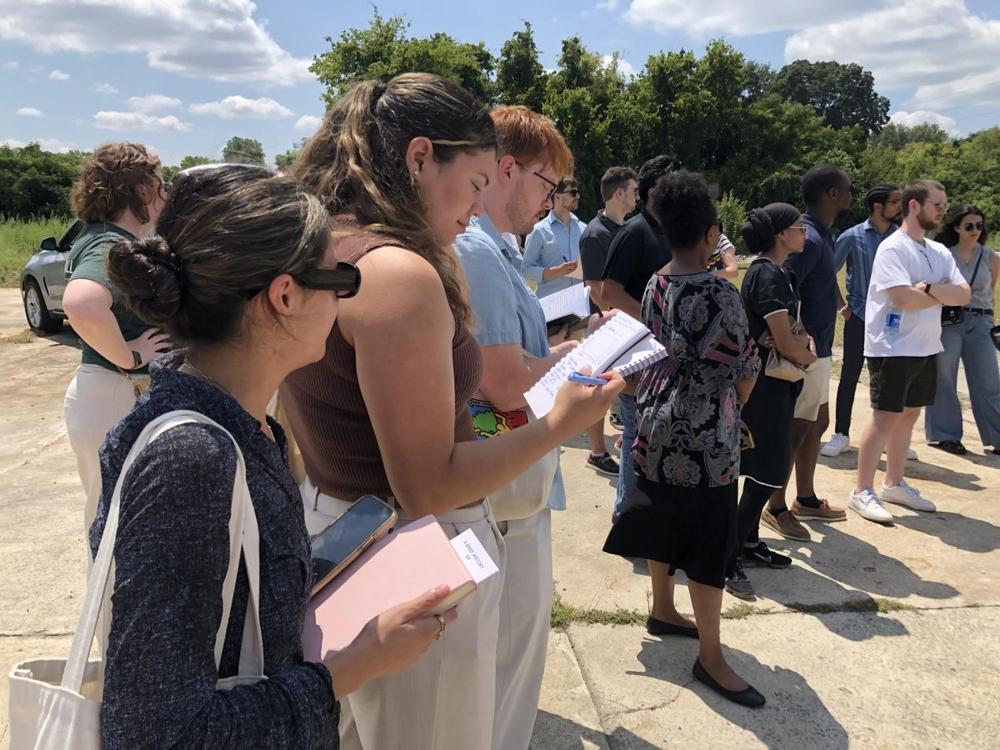 Kennesaw State University architecture student Sofia Gomez, left, listens as Macon leaders explain the vision to reinvigorate Macon’s old “Black Wall Street” known as Greenwood Bottom. Liz Fabian/Macon Newsroom