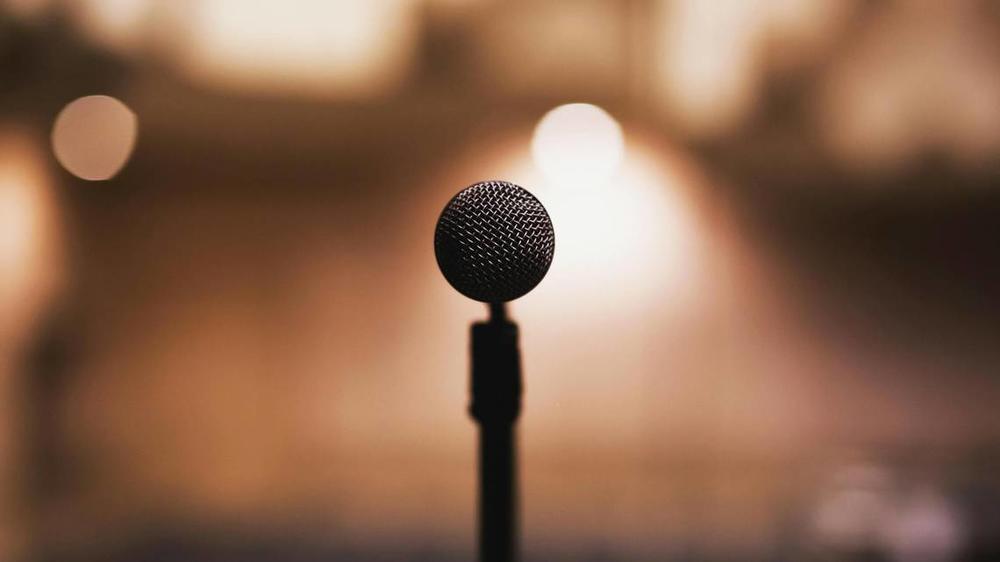 A stock photo of a microphone against a blurred background