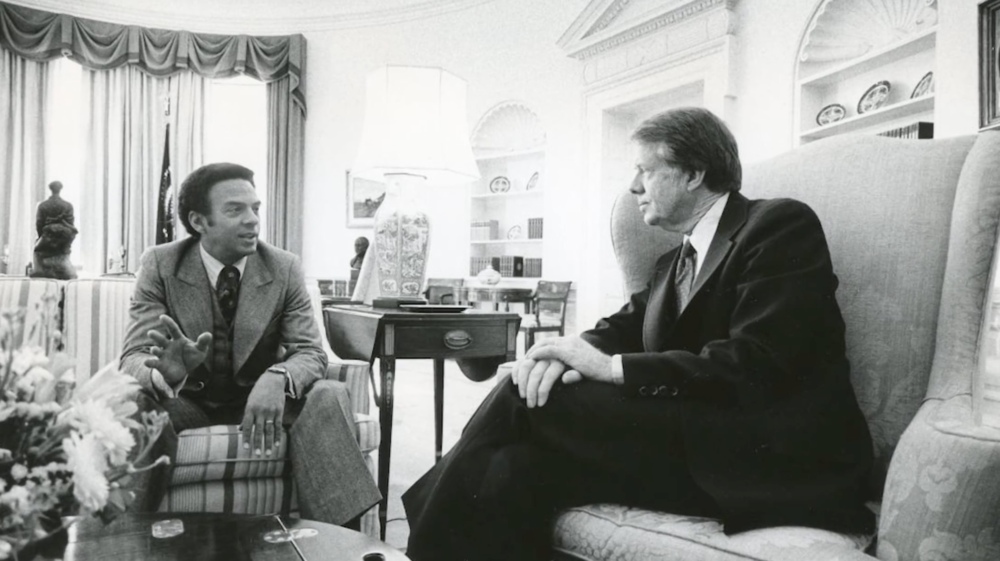 Andrew Young and Jimmy Carter sitting in the oval office.