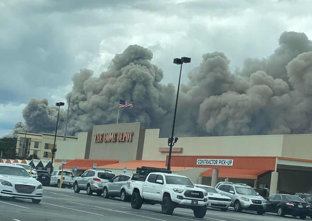 View from a Home Depot parking lot as smoke billows from a fire at the BioLab facility in Conyers, Ga., Sunday, Sept. 29, 2024.