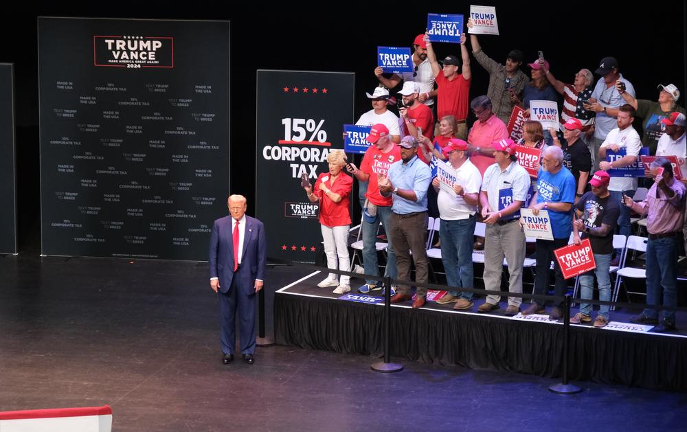 Trump waits to take to the podium as “God Bless the U.S.A.” by Lee Greenwood plays.