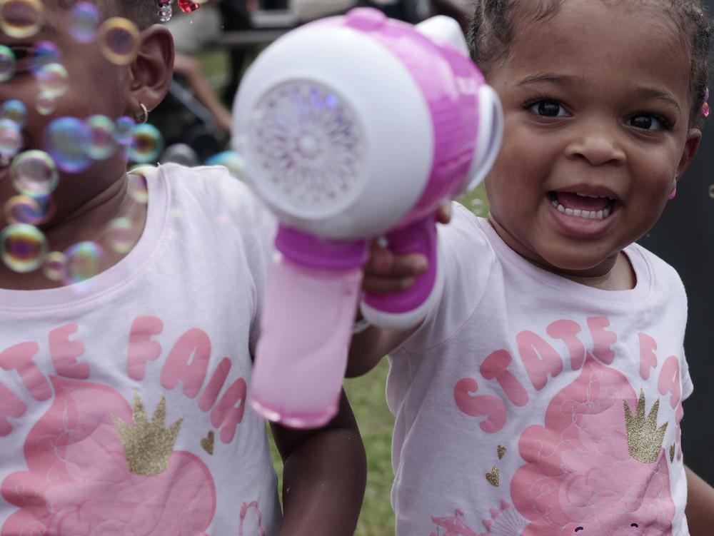 Justice Coker (left) and Journey Coker (right), twin four-year-olds, enjoy bubbles at the Georgia National Fair on Oct. 5 in Perry, Ga.