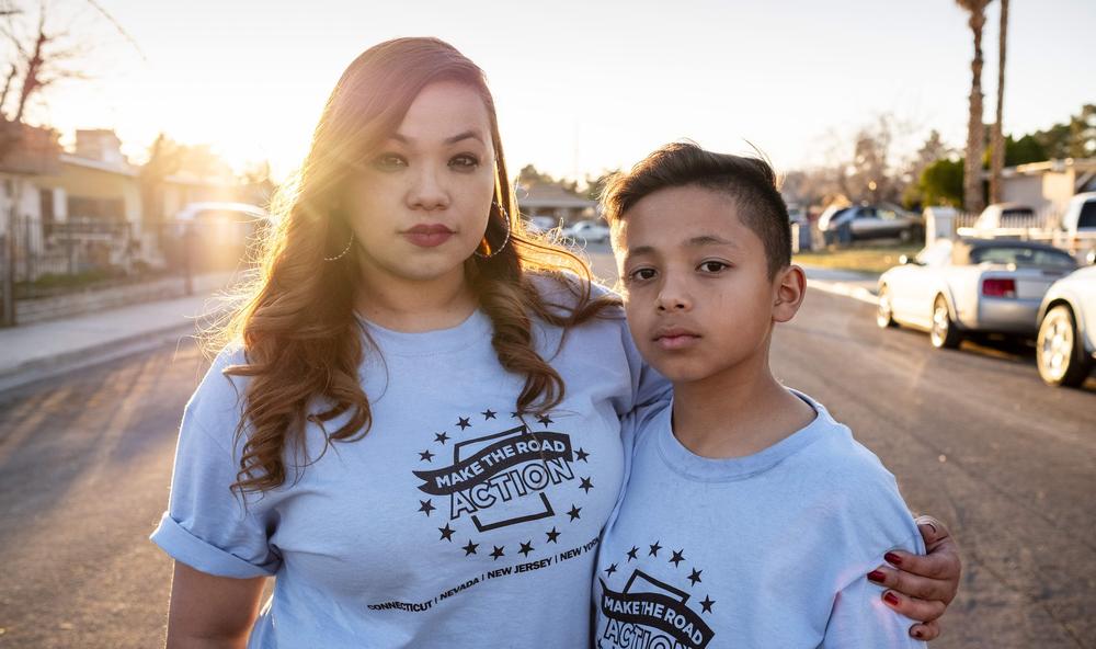 A mother and son embracing.