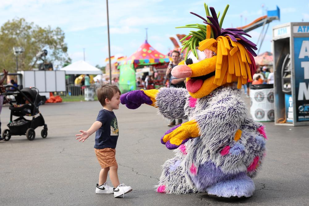 Michael Holakovsky, the 2-year-old son of Linds Holakovsky, goes to hug one of the Fritters characters on Saturday, Oct. 5, 2024 at the Georgia National Fair in Perry, Georgia. This was Michael and his family's first year at the fair after moving to Forsyth, Georgia from Illinois one year ago. (Photo/Ashtin Barker)