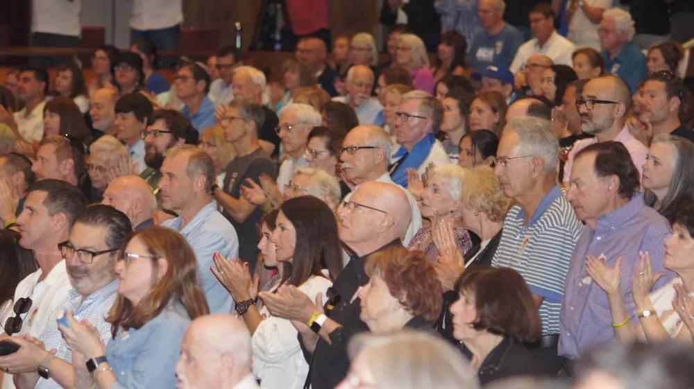 The crowd filled the 1,080-seat Byers Theatre in the Sandy Springs Performing Arts Center and thousands more watched on a large video screen on the City Green outside city hall. (Photo by Bob Pepalis)