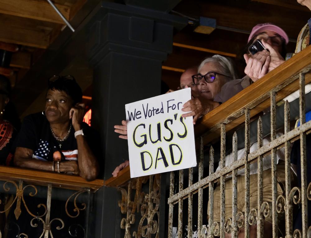 A supporter holds a sign referring to Walz's teenage son Gus, who was brought to tears during an emotional moment in his father's speech at the Democratic National Convention in August.