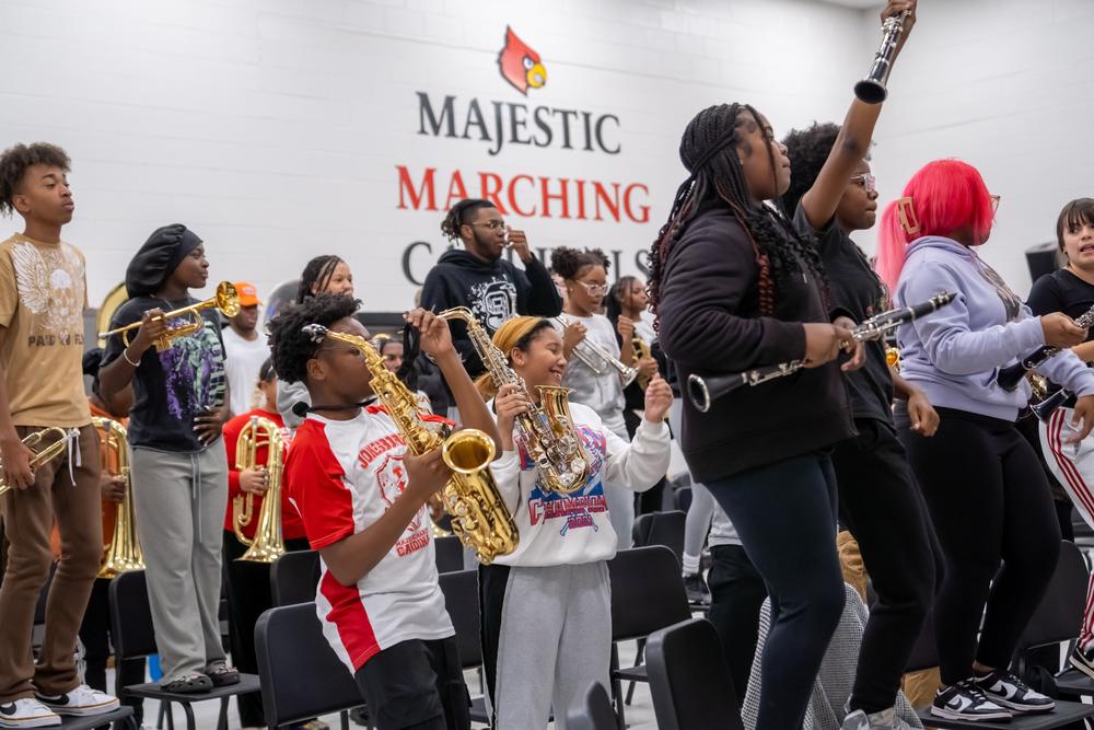 The Jonesboro High Majestic Marching Cardinals play their instruments during their final band practice before heading off to the Macy's Thanksgiving Day Parade.