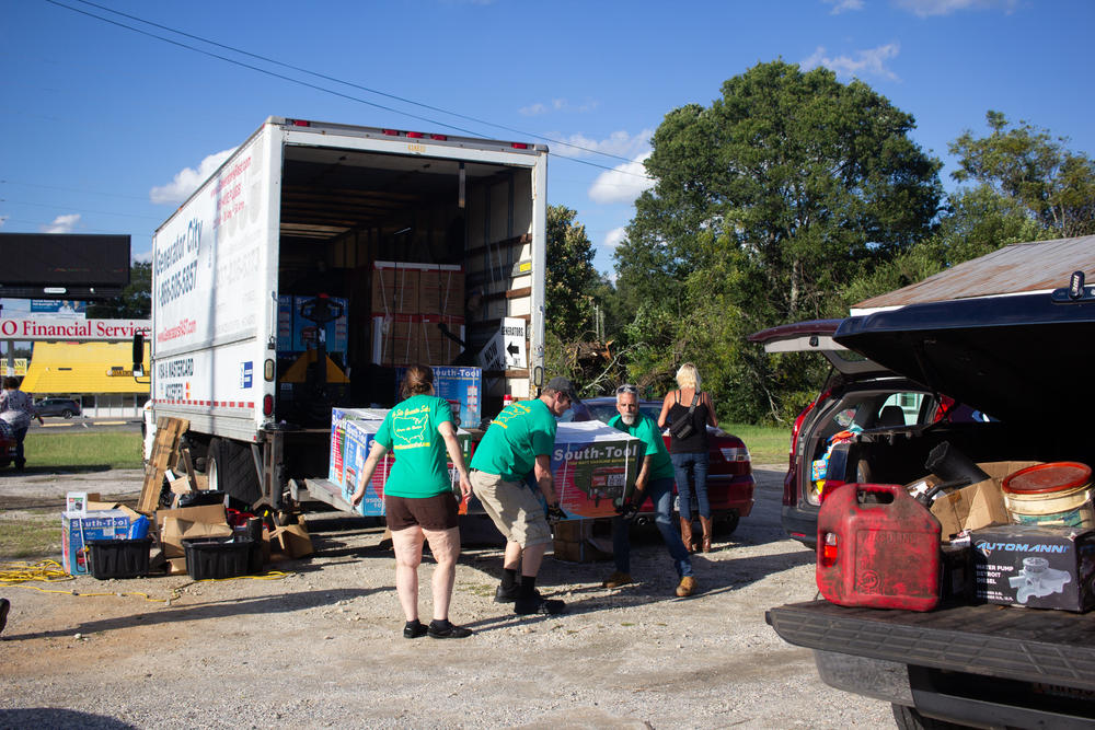 People line up to buy generators off a truck on Sept. 27 in Sandersville, Ga., in the wake of Hurricane Helene.