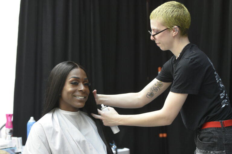 Jada Brooks gets her hair styled before posing for a new passport photo. Brooks said her top choice travel destination is Egypt. Ross Williams/Georgia Recorder