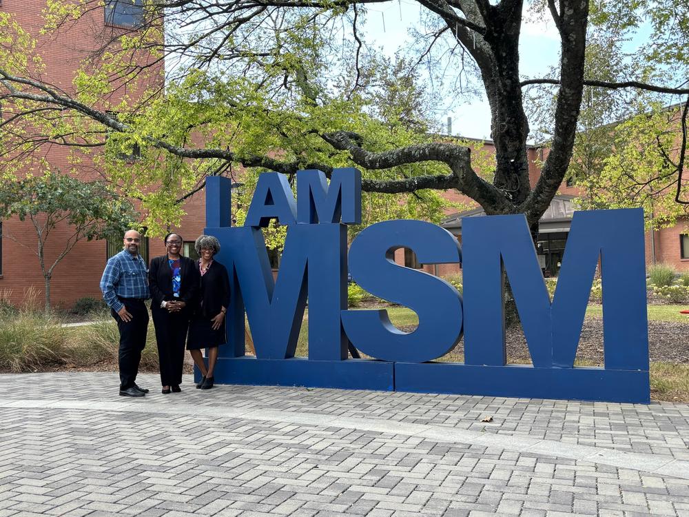 Christopher Ervin, Maisha Standifer and Folashade Omole stand in front of the I Am MSM sign at Morehouse School of Medicine in Atlanta