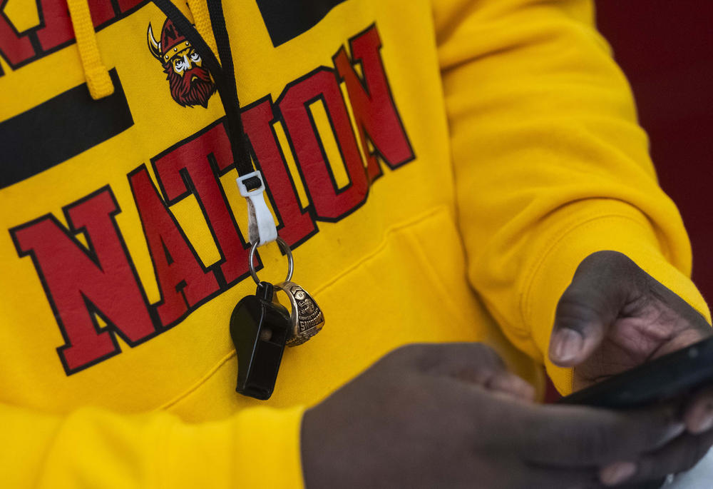 Northeast High School football head coach Jeremy Wiggins wears the FCS Championship ring he won as a cornerback at Appalachian State University on the same lanyard as his whistle. 